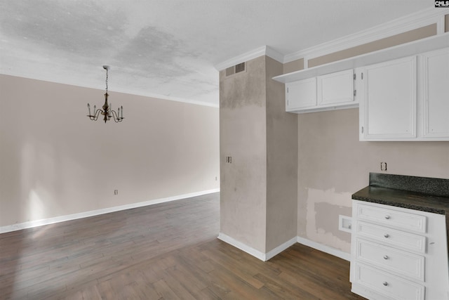 4712 Leaf Crest Ct, Columbia, SC 29210 - kitchen with dark countertops, a chandelier, dark wood-type flooring, baseboards, and white cabinets