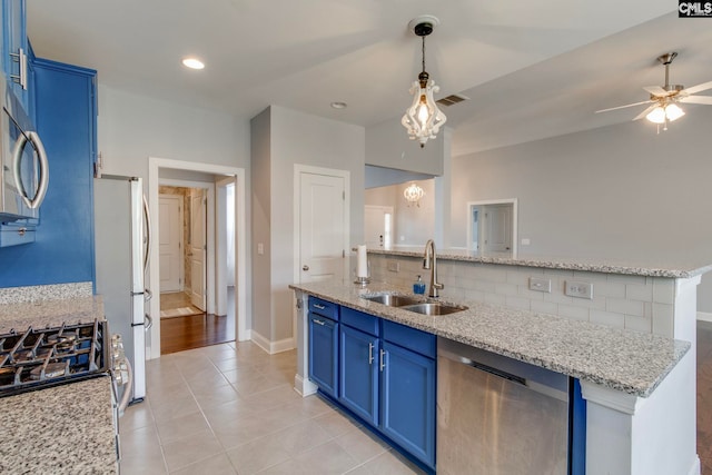 571 Maple Valley Loop, Blythewood, SC 29016 - kitchen with blue cabinets, stainless steel appliances, a sink, decorative backsplash, and an island with sink