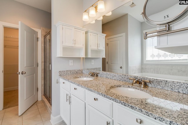 571 Maple Valley Loop, Blythewood, SC 29016 - bathroom with tile patterned floors, a stall shower, a walk in closet, double vanity, and a garden tub