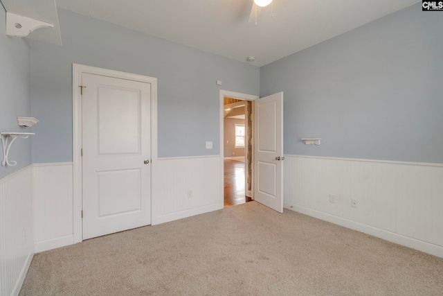 571 Maple Valley Loop, Blythewood, SC 29016 - unfurnished bedroom featuring wainscoting, carpet, and a ceiling fan