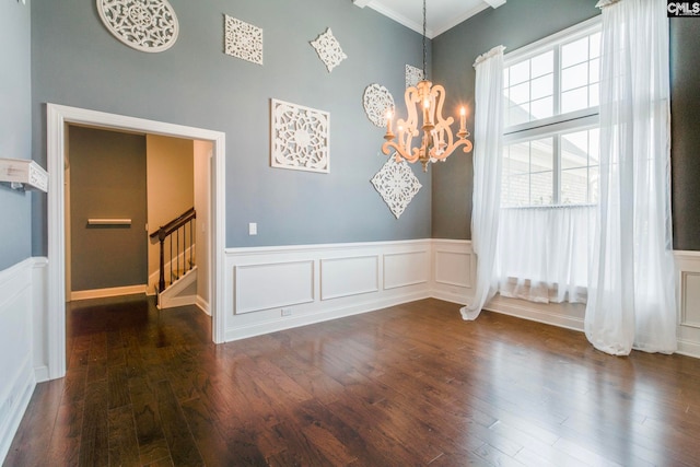 571 Maple Valley Loop, Blythewood, SC 29016 - unfurnished dining area with a chandelier, stairway, ornamental molding, a decorative wall, and wood finished floors