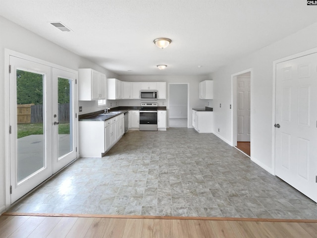 186 Fallstaff Rd, Columbia, SC 29229 - kitchen featuring appliances with stainless steel finishes, a sink, white cabinetry, and dark countertops