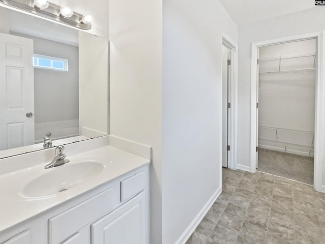186 Fallstaff Rd, Columbia, SC 29229 - bathroom with vanity, baseboards, and a walk in closet