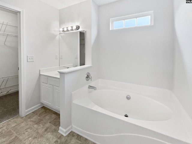 186 Fallstaff Rd, Columbia, SC 29229 - full bathroom featuring a garden tub, vanity, a spacious closet, and baseboards