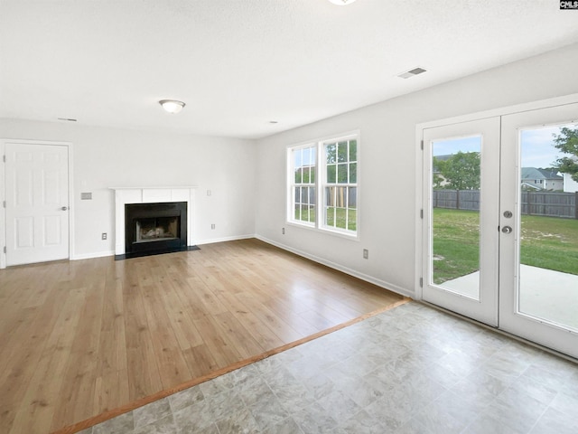 186 Fallstaff Rd, Columbia, SC 29229 - unfurnished living room featuring a fireplace with flush hearth, baseboards, french doors, and wood finished floors