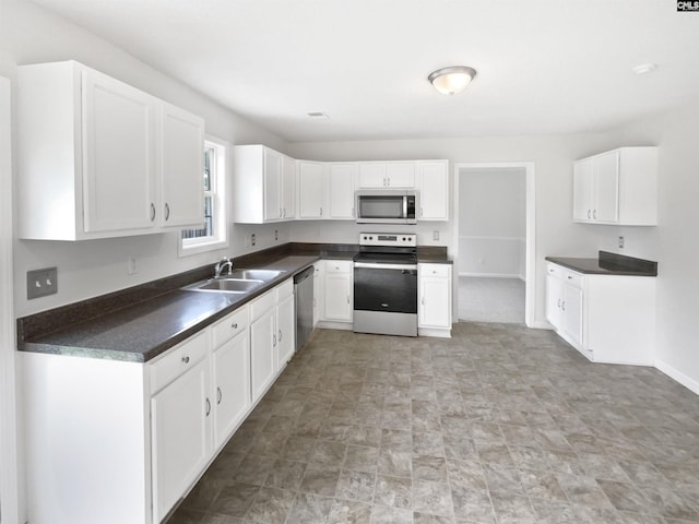 186 Fallstaff Rd, Columbia, SC 29229 - kitchen with stainless steel appliances, a sink, dark countertops, and white cabinetry