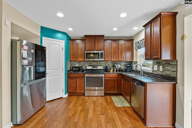 17 Cypress Cove Rd, Columbia, SC 29229 - kitchen featuring appliances with stainless steel finishes, a sink, light wood-type flooring, tasteful backsplash, and recessed lighting