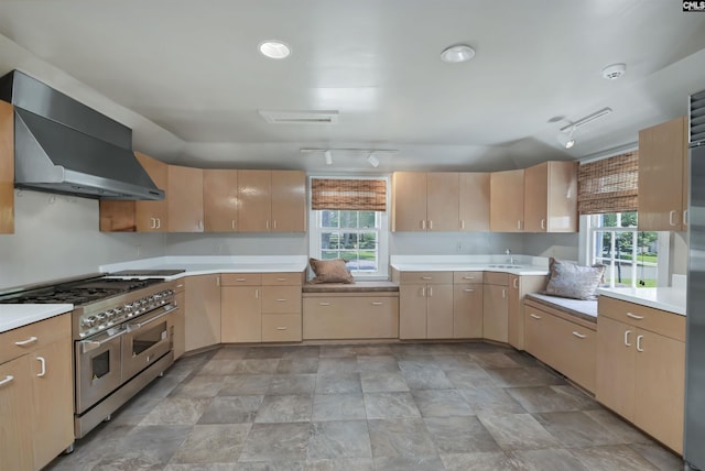 723 Hampton Hill Rd, Columbia, SC 29209 - kitchen featuring range with two ovens, wall chimney range hood, rail lighting, and light countertops