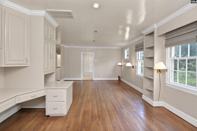 723 Hampton Hill Rd, Columbia, SC 29209 - unfurnished office with built in desk, wood finished floors, baseboards, and crown molding