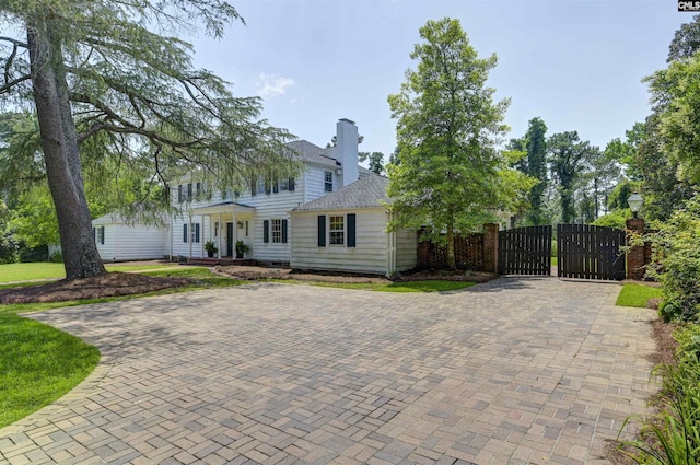 723 Hampton Hill Rd, Columbia, SC 29209 - colonial inspired home featuring a gate, roof with shingles, decorative driveway, and a chimney