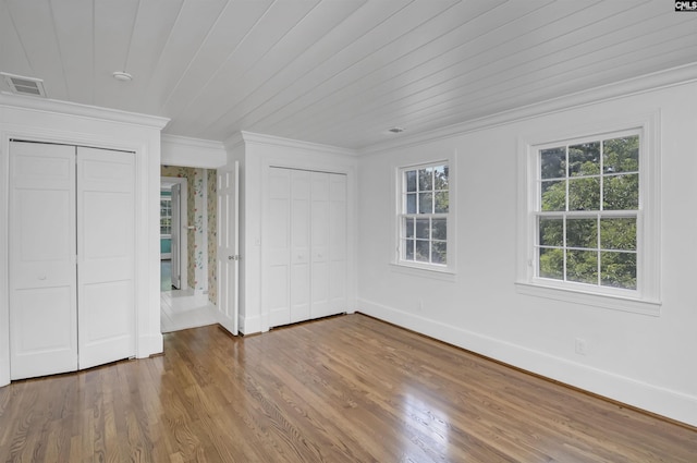 723 Hampton Hill Rd, Columbia, SC 29209 - unfurnished bedroom with ornamental molding, multiple closets, baseboards, and wood finished floors