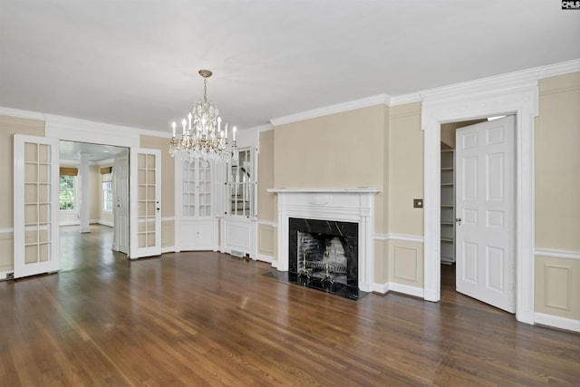 723 Hampton Hill Rd, Columbia, SC 29209 - unfurnished living room featuring crown molding, wood finished floors, a chandelier, built in shelves, and a high end fireplace