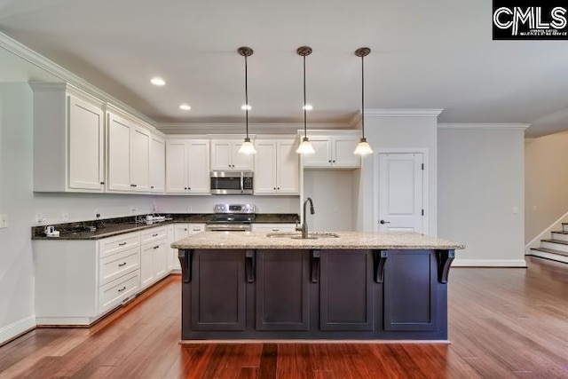 120 Mclaw Ln, Gilbert, SC 29054 - kitchen featuring appliances with stainless steel finishes, a sink, dark wood-style floors, white cabinetry, and baseboards