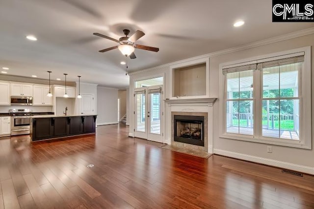120 Mclaw Ln, Gilbert, SC 29054 - unfurnished living room featuring ornamental molding, ceiling fan, a tile fireplace, dark wood finished floors, and baseboards