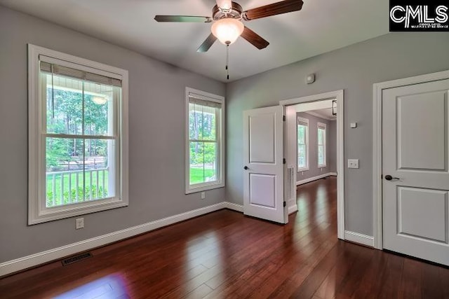 120 Mclaw Ln, Gilbert, SC 29054 - unfurnished bedroom featuring multiple windows, dark wood-style flooring, and baseboards
