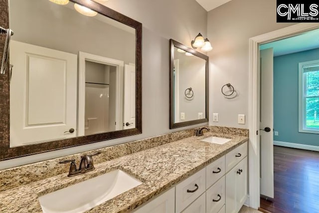 120 Mclaw Ln, Gilbert, SC 29054 - bathroom featuring double vanity, wood finished floors, and baseboards