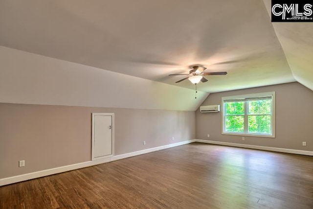 120 Mclaw Ln, Gilbert, SC 29054 - additional living space with a wall mounted air conditioner, a ceiling fan, dark wood-style flooring, vaulted ceiling, and baseboards