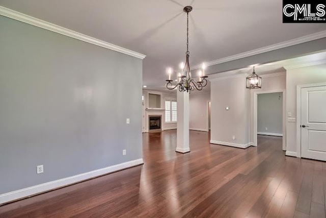 120 Mclaw Ln, Gilbert, SC 29054 - unfurnished dining area with a chandelier, baseboards, dark wood-style floors, crown molding, and a fireplace