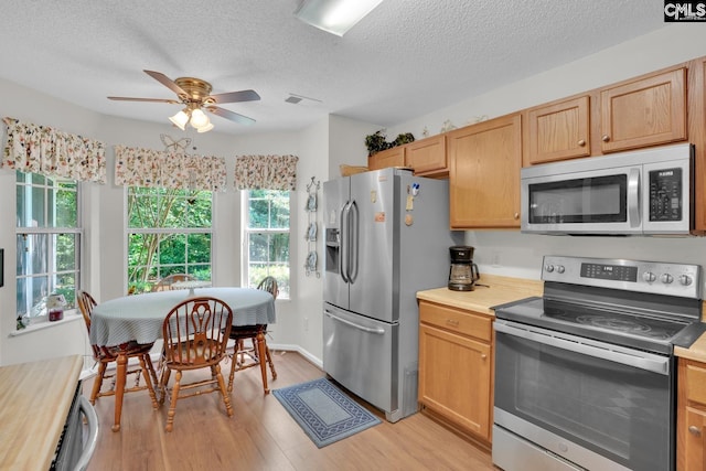 24 Stoney Pointe Dr, Chapin, SC 29036 - kitchen with stainless steel appliances, ceiling fan, light wood-style flooring, and a textured ceiling