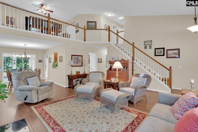 24 Stoney Pointe Dr, Chapin, SC 29036 - living area featuring stairway, wood finished floors, a ceiling fan, a chandelier, and a towering ceiling