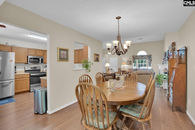 24 Stoney Pointe Dr, Chapin, SC 29036 - dining room featuring light wood finished floors, a chandelier, and baseboards