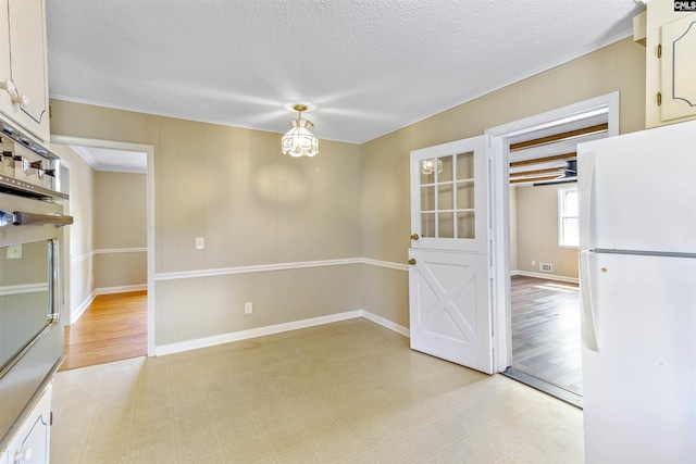 1109 F Ave, Cayce, SC 29033 - unfurnished dining area featuring light flooring, a textured ceiling, crown molding, and baseboards