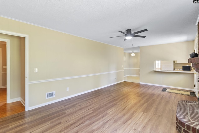 1109 F Ave, Cayce, SC 29033 - unfurnished living room with a ceiling fan, wood finished floors, a textured ceiling, and baseboards