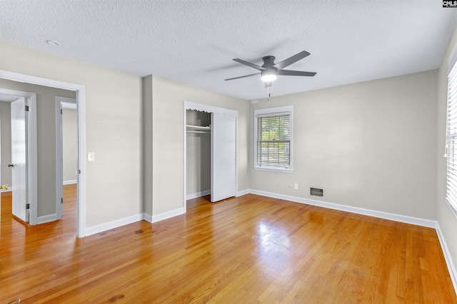 1109 F Ave, Cayce, SC 29033 - unfurnished bedroom featuring a closet, light wood finished floors, a textured ceiling, baseboards, and a ceiling fan