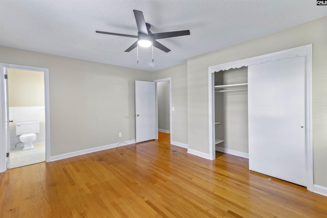 1109 F Ave, Cayce, SC 29033 - unfurnished bedroom with light wood finished floors, a closet, connected bathroom, ceiling fan, and a textured ceiling