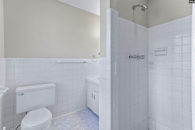 1109 F Ave, Cayce, SC 29033 - bathroom with wainscoting, tiled shower, toilet, vanity, and tile walls