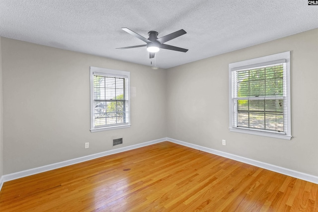 1109 F Ave, Cayce, SC 29033 - spare room with light wood-type flooring, baseboards, ceiling fan, and a textured ceiling
