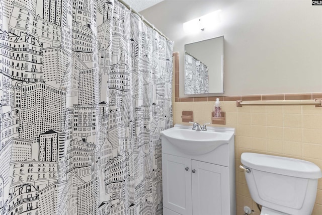 1109 F Ave, Cayce, SC 29033 - full bathroom featuring vanity, tile walls, toilet, wainscoting, and a shower with shower curtain