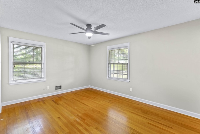 1109 F Ave, Cayce, SC 29033 - empty room with light wood finished floors, baseboards, a textured ceiling, and a ceiling fan