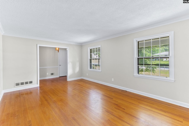 1109 F Ave, Cayce, SC 29033 - spare room with a textured ceiling, healthy amount of natural light, ornamental molding, light wood-style floors, and baseboards