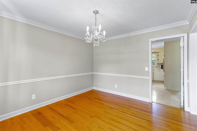 1109 F Ave, Cayce, SC 29033 - unfurnished room featuring a chandelier, light wood finished floors, ornamental molding, a textured ceiling, and baseboards