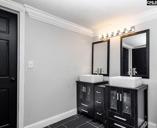 3715 Palmetto Ave, Columbia, SC 29203 - bathroom featuring double vanity, tile patterned floors, crown molding, baseboards, and a textured ceiling