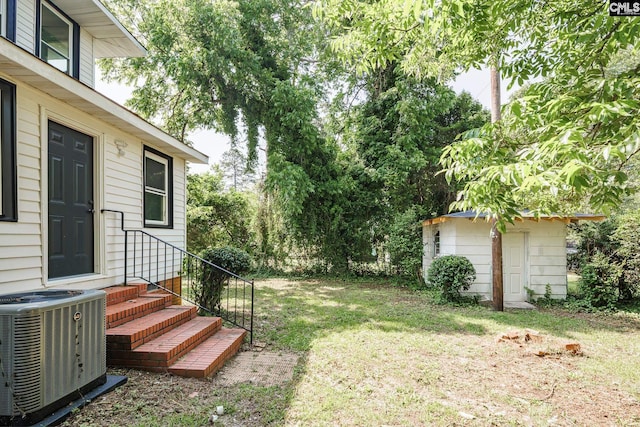 3715 Palmetto Ave, Columbia, SC 29203 - view of green lawn featuring central air condition unit and an outdoor structure
