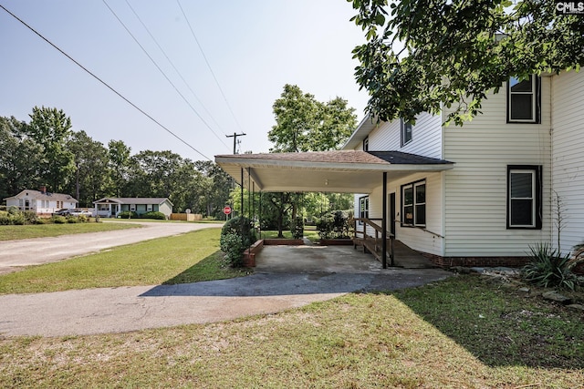 3715 Palmetto Ave, Columbia, SC 29203 - view of green lawn with driveway and a carport
