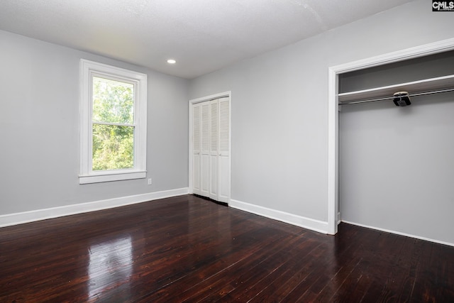 3715 Palmetto Ave, Columbia, SC 29203 - unfurnished bedroom featuring multiple closets, dark wood finished floors, baseboards, and recessed lighting