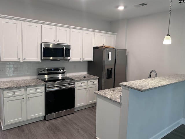 739 Jacobs Mill Pond Rd Unit 21, Elgin, SC 29045 - kitchen featuring stainless steel appliances, dark wood finished floors, white cabinets, and backsplash