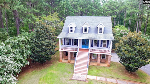 2492 Harbor View Rd, Camden, SC 29020 - view of front facade featuring stairway, a forest view, a front lawn, and a porch