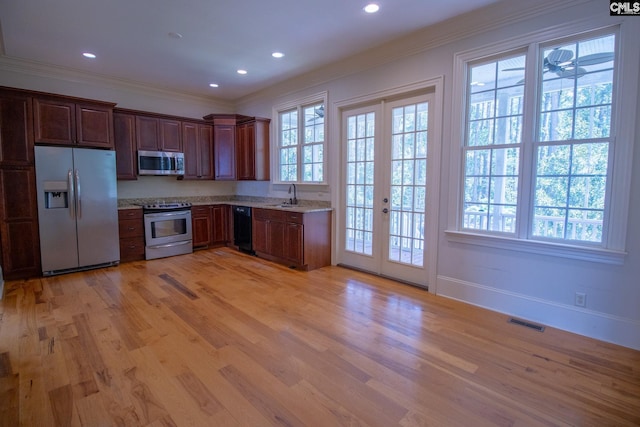 2492 Harbor View Rd, Camden, SC 29020 - kitchen with stainless steel appliances, light wood-style flooring, ornamental molding, light stone countertops, and french doors
