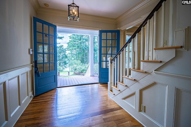 2492 Harbor View Rd, Camden, SC 29020 - entrance foyer featuring stairs, a decorative wall, crown molding, wood finished floors, and a chandelier
