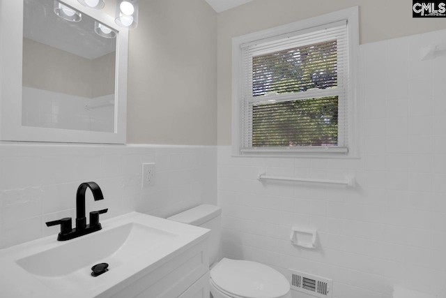 1605 Overhill Rd, Columbia, SC 29223 - bathroom featuring tile walls, toilet, vanity, and a wainscoted wall