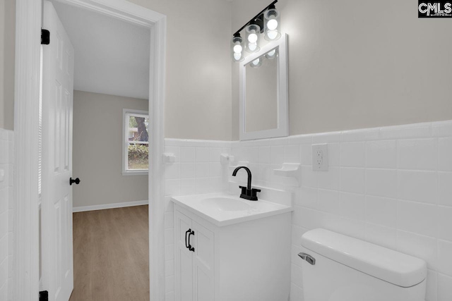 1605 Overhill Rd, Columbia, SC 29223 - half bathroom with vanity, toilet, tile walls, and wood finished floors