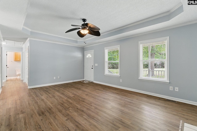 1149 Pond Branch Rd, Gilbert, SC 29054 - empty room with a raised ceiling, ornamental molding, a textured ceiling, attic access, and wood finished floors