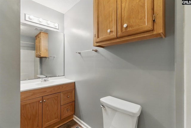 1149 Pond Branch Rd, Gilbert, SC 29054 - half bath with toilet, vanity, wood finished floors, and baseboards
