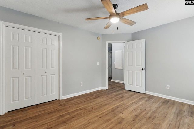 1149 Pond Branch Rd, Gilbert, SC 29054 - unfurnished bedroom with wood finished floors, baseboards, a closet, ceiling fan, and a textured ceiling