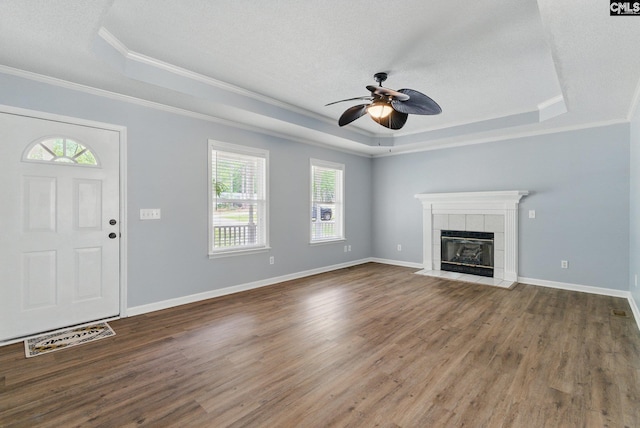 1149 Pond Branch Rd, Gilbert, SC 29054 - unfurnished living room featuring a raised ceiling, ornamental molding, a ceiling fan, wood finished floors, and a tiled fireplace