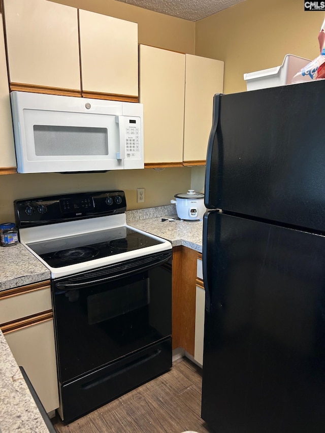 1600 Park Cir Unit 802, Columbia, SC 29201 - kitchen with range with electric stovetop, white microwave, freestanding refrigerator, and light countertops